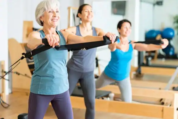 older woman doing weight training Basingstoke  and resistance in the gym to tone upper arms